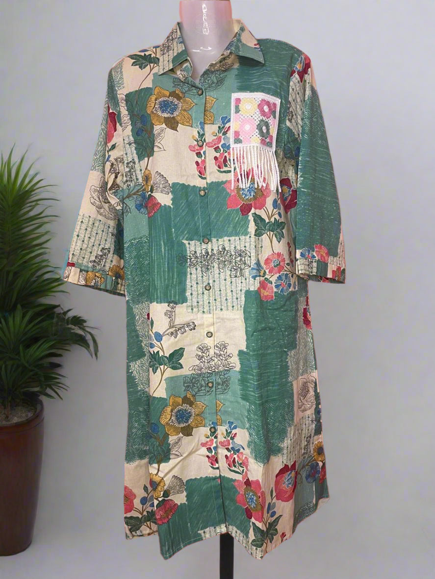 Colorful patchwork dress on a mannequin against a pink background